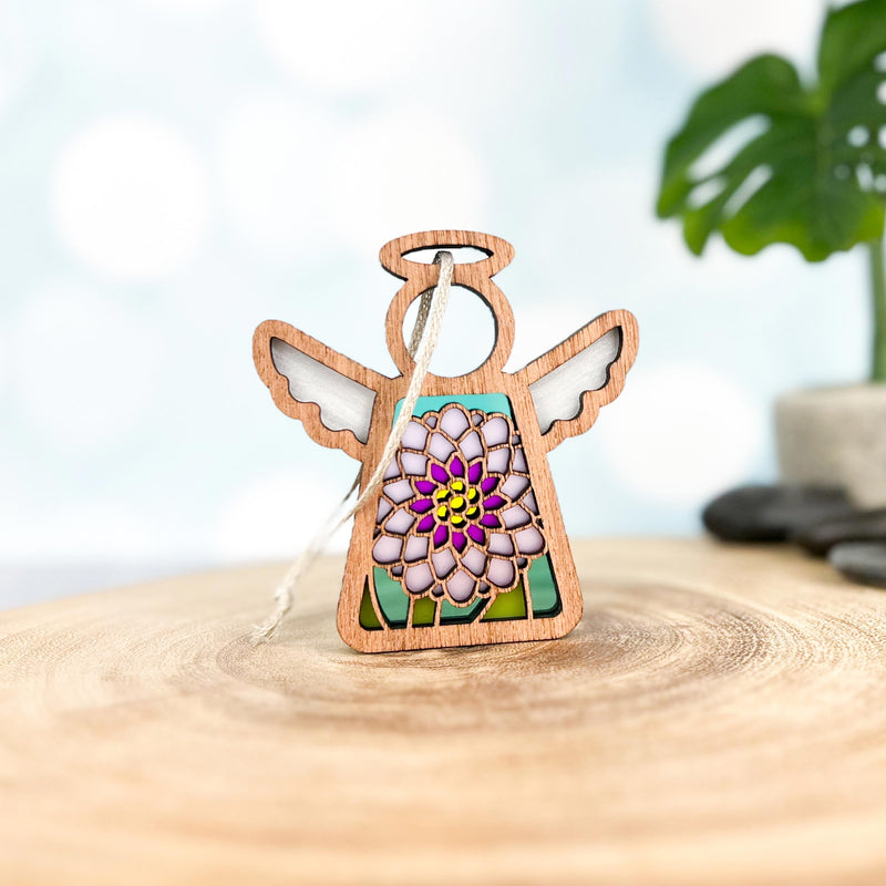 The Forged Flare® Chrysanthemum Ornament with Imperfections is a 3.5" Mother's Angels® wooden angel figurine featuring stained glass wings and a vibrant floral centerpiece—a beautiful handcrafted collectible.