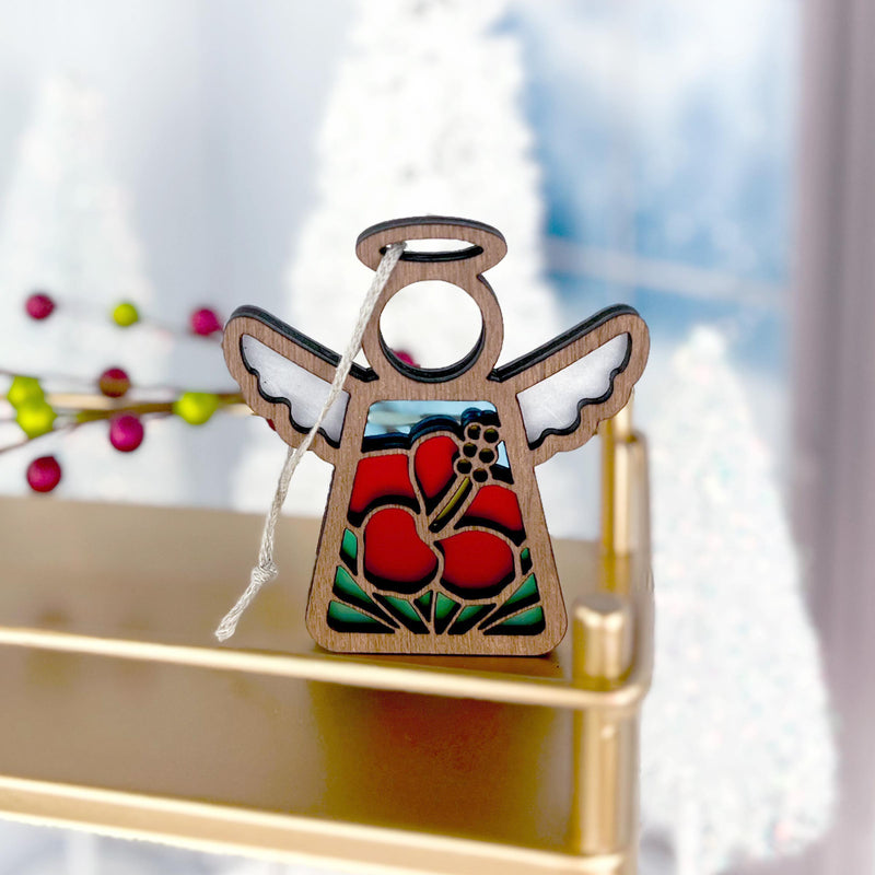 The Forged Flare® Hibiscus Ornament | 3.5" (H) Angel Figurine by Mother's Angels® features wood, cut-out wings, and red hibiscus stained glass, hanging by a white string—perfect for adding Hawaiian charm to your Christmas décor.