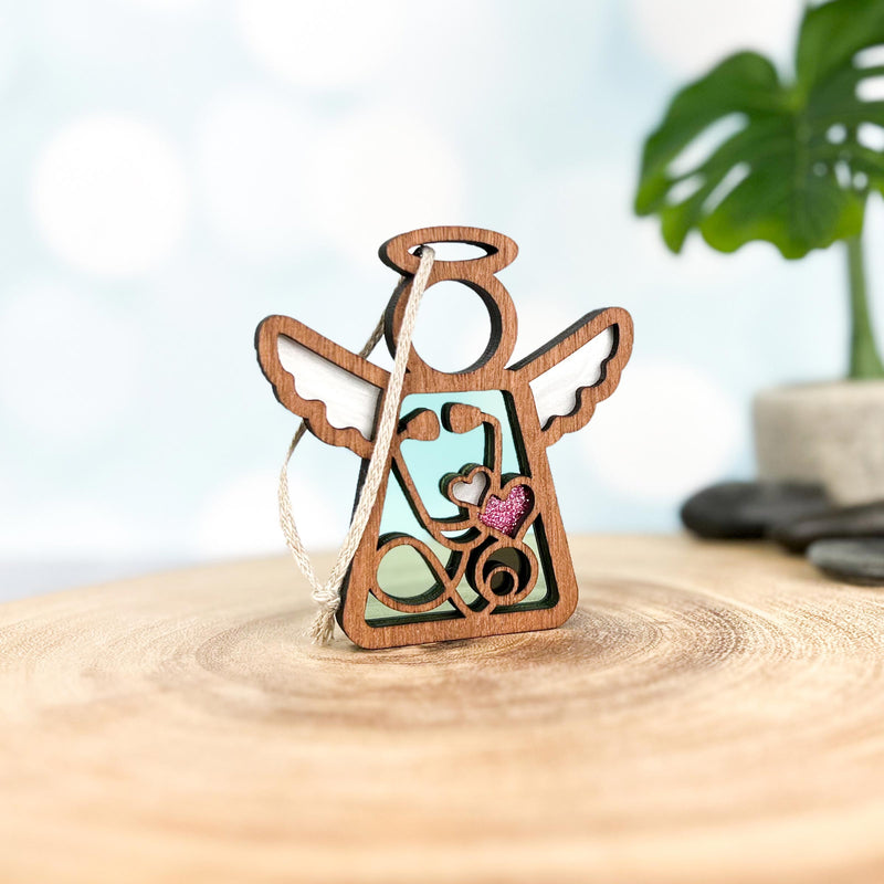 The Forged Flare® Doctor/Nurse Ornament, a 3.5" wooden angel figurine from Mother's Angels®, features a pink glitter heart and string for hanging—perfect as a nurse appreciation gift or charming decor.