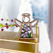 The Forged Flare® Mother's Angels® 3.5" Playful Purple Butterflies Ornament features stained glass-style wings and purple accents, displayed on a gold shelf with festive décor—ideal for collectors shopping on Amazon.