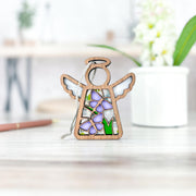 A 3.5" Mother's Angels® angel figurine by Forged Flare®, featuring playful purple butterflies, stands on a light surface—ideal for collectors shopping Warehouse Return items on Amazon.