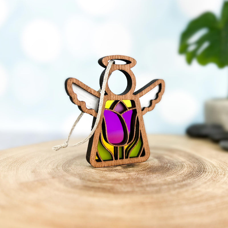 The Mother's Angels® 3.5" Tulip Ornament by Forged Flare® is a wooden angel figurine featuring a stained-glass-style purple tulip, symbolizing hope and renewal—ideal as angel or flower decor.