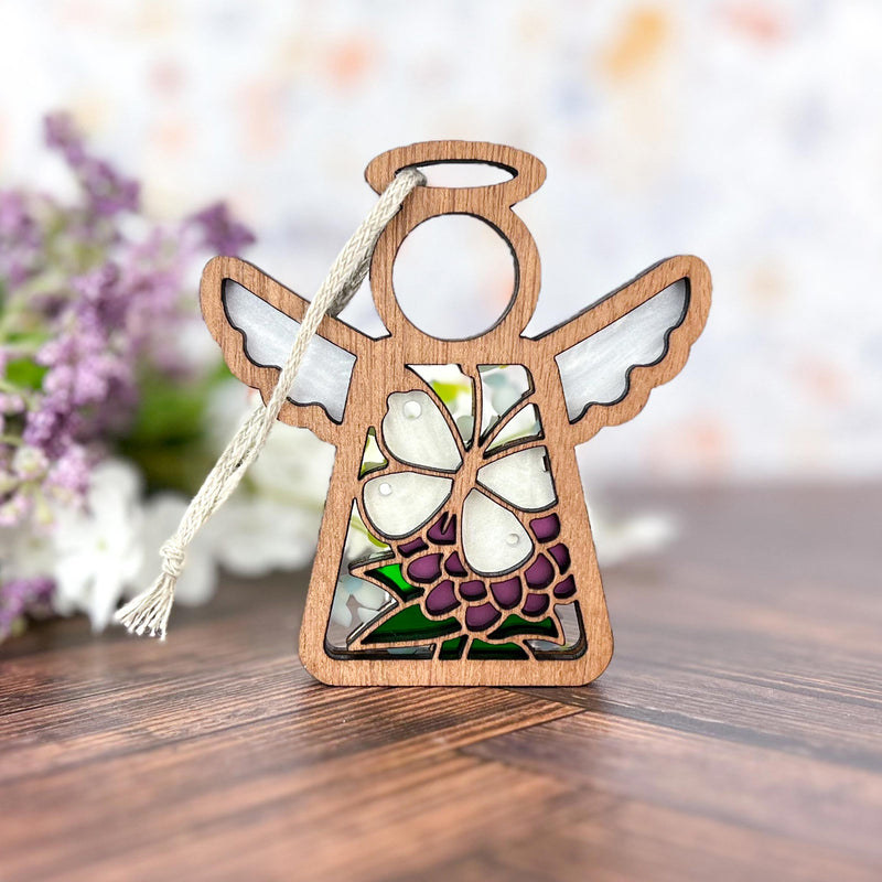 The Forged Flare® Mother's Angels® Cabbage Butterfly with Clover Flower Ornament is a 3.5" wooden angel figurine with white wings, a stained glass-style floral design, purple flower, butterfly accents, and hanging string.