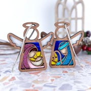 The Forged Flare® Christmas Nativity 2-Piece Bundle features 3.5" wooden angel ornaments from Mother's Angels®, each depicting Mary, Joseph, and baby Jesus in colorful stained-glass-style scenes.