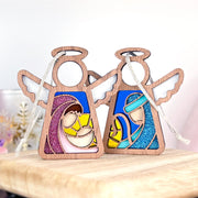 The Forged Flare® Christmas Nativity 2-Piece Bundle includes two 3.5" Mother's Angels® wooden angel figurines featuring stained glass-style designs of Mary, Joseph, and baby Jesus in soft pink, yellow, and blue hues.