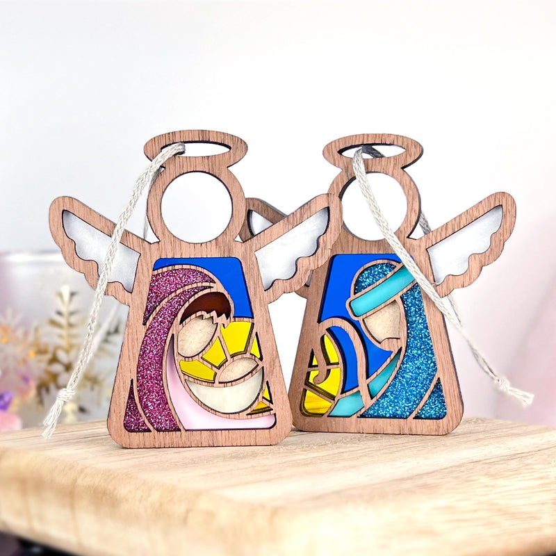 The Forged Flare® Christmas Nativity 2-Piece Bundle includes two 3.5" Mother's Angels® wooden angel figurines featuring stained glass-style designs of Mary, Joseph, and baby Jesus in soft pink, yellow, and blue hues.