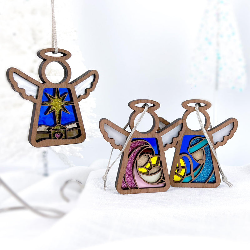 The Forged Flare® Christmas Nativity 3-Piece Bundle features 3.5" stained glass-style angel figurines: one star ornament and two showing the Holy Family—Mary, Joseph, and Baby Jesus—in vibrant colors from Mother's Angels®.