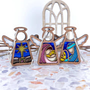 The Forged Flare® Christmas Nativity 3-Piece Bundle features 3.5" stained glass-style angel figurines—Star, Mary with baby Jesus, and Joseph—creating a charming nativity scene from the Mother's Angels® collection.