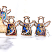 The Christmas Nativity 3-Piece Bundle by Forged Flare® features three wooden angel ornaments, each standing 3.5 inches tall. These beautifully crafted Mother's Angels® are adorned with vibrant inlay designs in hues of blue, purple, red, and green. Each angel is designed with a circular halo and wings and comes equipped with a string for easy hanging, making them perfect decor for your Christmas tree during nativity celebrations.