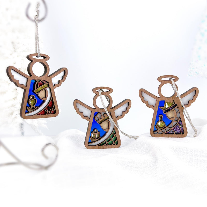 The Forged Flare® Christmas Nativity 3-Piece Bundle features three 3.5" Mother's Angels® ornaments with stained-glass-style blue panels and Wise Men scenes, perfect as festive holiday decor.