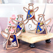 The Forged Flare® Christmas Nativity 4-Piece Bundle includes three Wise Men and a shepherd as 3.5" Mother's Angels® ornaments, each holding a nativity-inspired object and displayed on a wooden stand for festive decor.