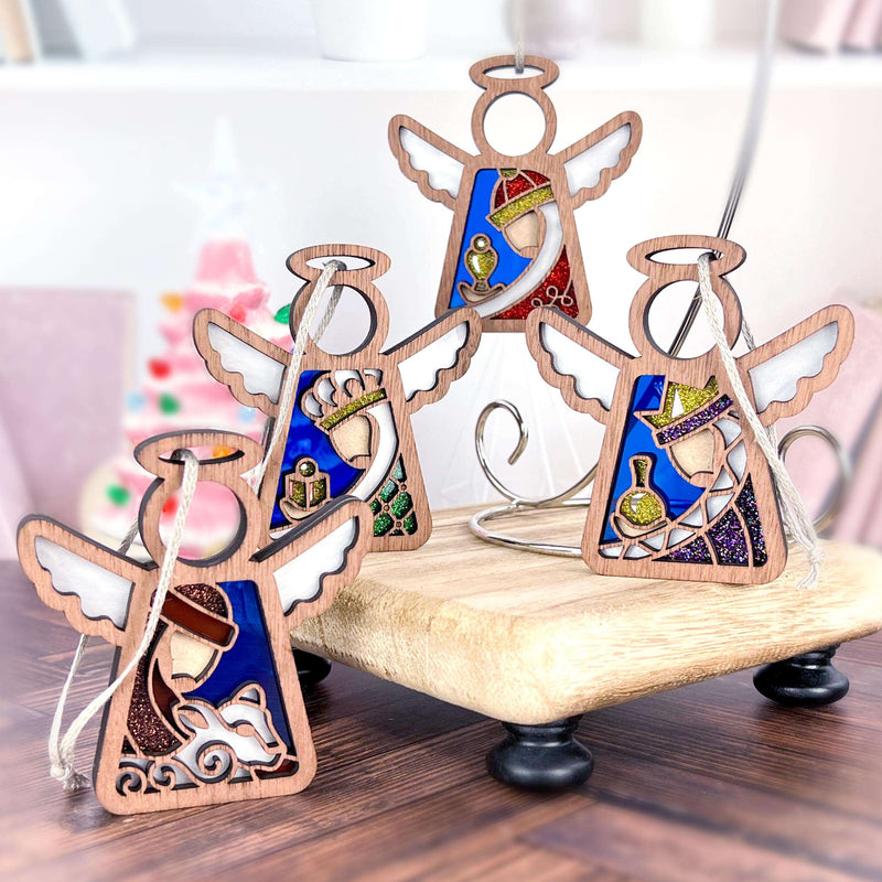 The Forged Flare® Christmas Nativity 4-Piece Bundle includes three Wise Men and a shepherd as 3.5" Mother's Angels® ornaments, each holding a nativity-inspired object and displayed on a wooden stand for festive decor.
