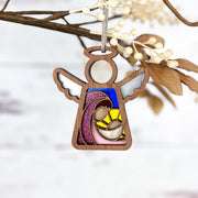 The Forged Flare® Mother's Angels® Christmas Nativity Mary Mother of Jesus 3.5" angel figurine features Mary, Joseph, and baby Jesus in stained glass-style under a yellow star, with silver wings—perfect as a charming Christmas decor or Nativity gift.