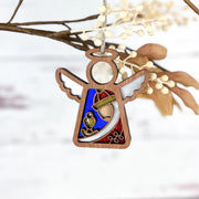 The Forged Flare® Christmas Nativity Red Wise Man 3.5" Angel Figurine from the Mother's Angels® collection features colorful stained glass-like details and white wings—perfect as a charming ornament for your holiday tree.