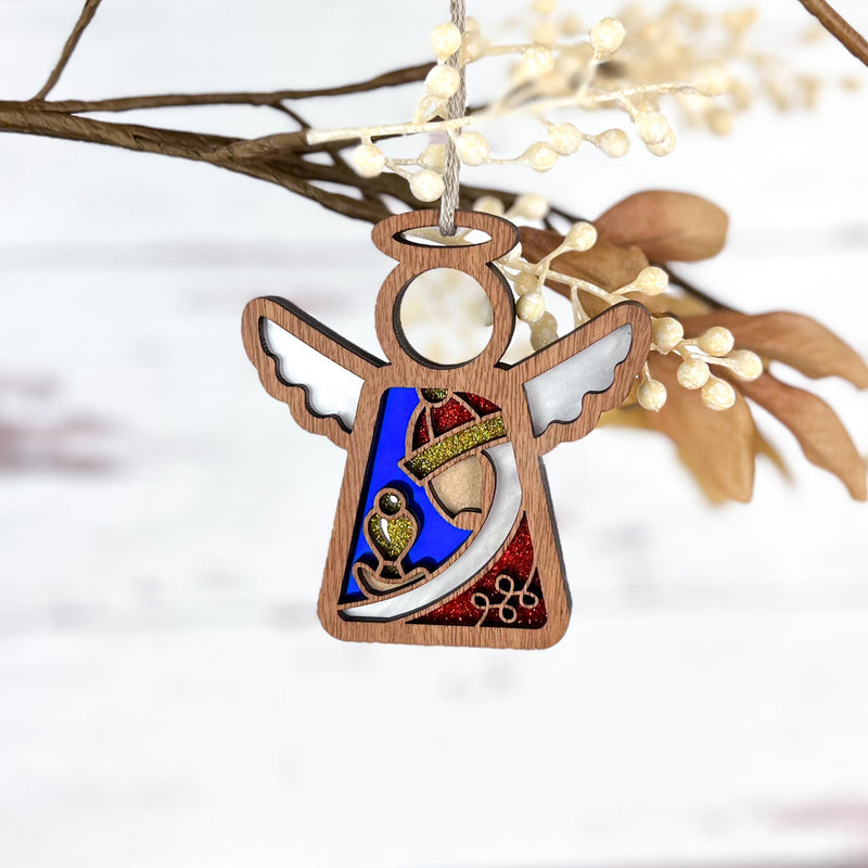 The Forged Flare® Christmas Nativity Red Wise Man 3.5" Angel Figurine from the Mother's Angels® collection features colorful stained glass-like details and white wings—perfect as a charming ornament for your holiday tree.