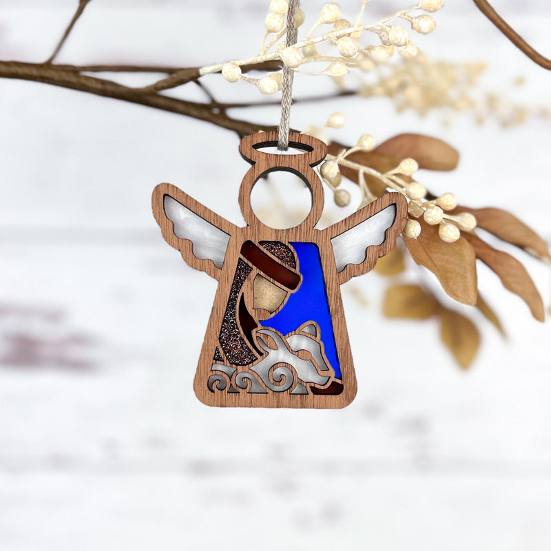 The Forged Flare® Christmas Nativity Shepherd With Sheep 3.5" (H) Angel Figurine from Mother's Angels® is a charming seasonal ornament, depicting an angel with a shepherd and sheep—perfect as a thoughtful Nativity gift.