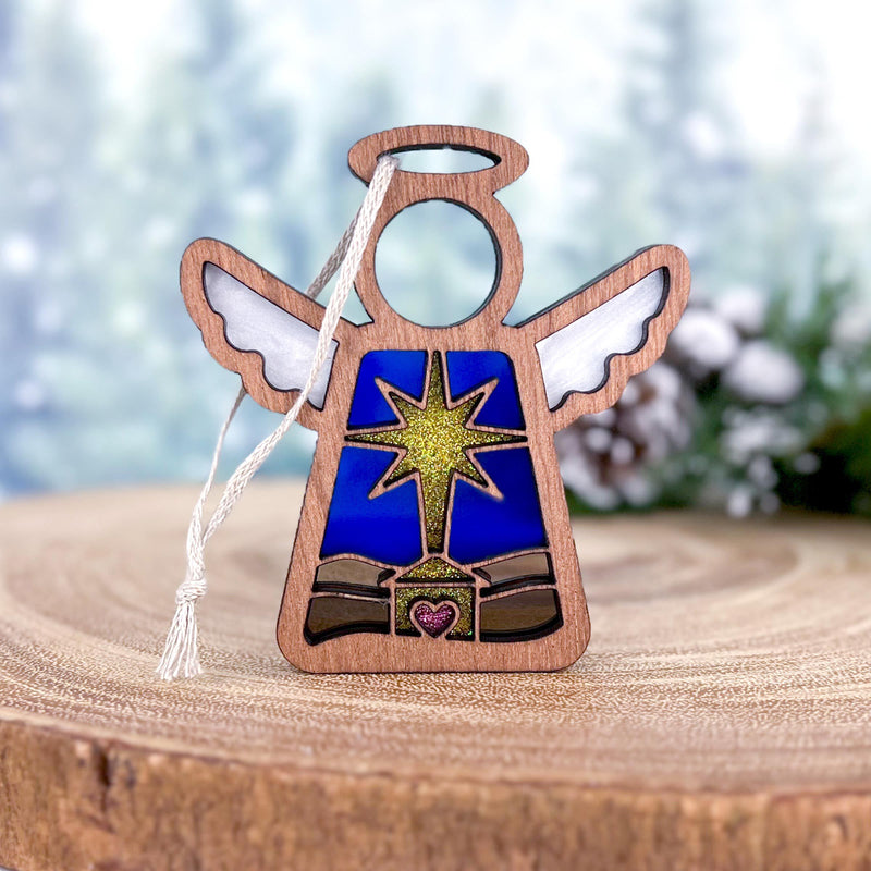 The Forged Flare® Christmas Nativity Star with Imperfections is a 3.5" Mother's Angels® ornament, featuring an angel figurine with white wings and gold halo—a meaningful holiday gift for your decorations.