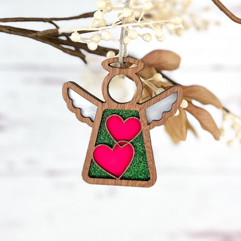 The Forged Flare® Limited Edition Interlocking Hearts Ornament – Series 8 features a 3.5" Mother's Angels® figurine with white wings, halo, and two pink hearts—perfect as a charming Christmas tree decoration.