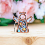 The Forged Flare® Warehouse Return - Daisy Ornament is a 3.5" Mother's Angels® figurine with blue wings, yellow daisies, and a twine loop—ideal for collectors and available on Amazon.
