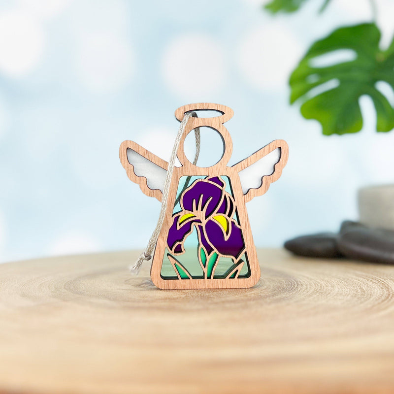 The Forged Flare® Mother's Angels® Iris Ornament is a 3.5" wooden angel figurine featuring a purple iris flower design—ideal for angel collections or as unique floral decor.