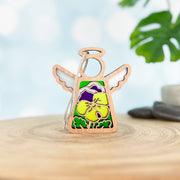 The Forged Flare® Pansy Ornament is a 3.5" Mother's Angels® figurine with white wings and a yellow-purple pansy design, perfect for your Christmas tree or angel collection. Display it on any surface with its charming, handcrafted look.