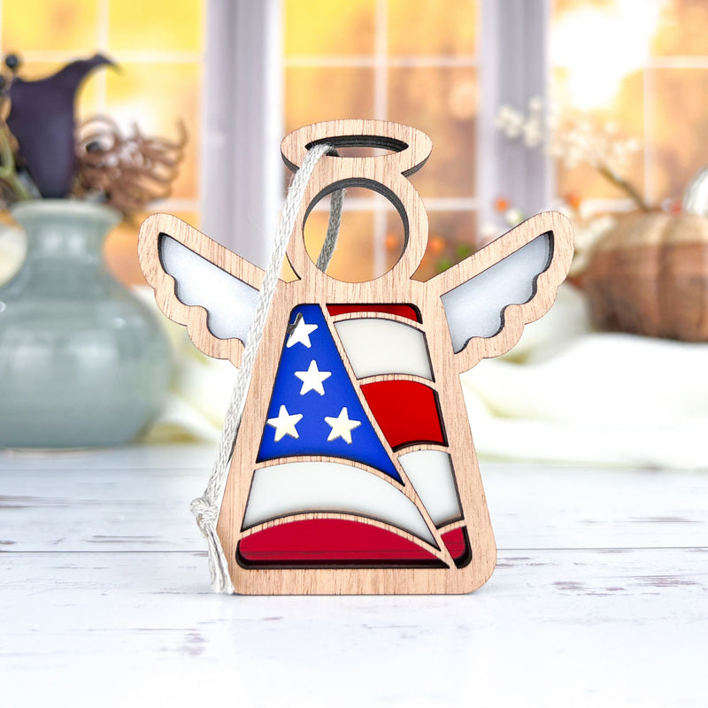 The Forged Flare® Mother's Angels® 3.5" American Flag Ornament features an angel in blue, white, and red with wings—perfect as a patriotic gift or Christmas tree ornament.