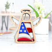 The Forged Flare® American Flag Ornament is a 3.5" Mother's Angels® figurine featuring a cut-out wooden angel design with an American flag pattern and hanging cord—an ideal patriotic gift for your decor.