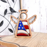 The Forged Flare® Mother's Angels® 3.5" American Flag Ornament features a wooden angel figurine painted with stars and stripes, perfect as a patriotic gift or Christmas decoration.
