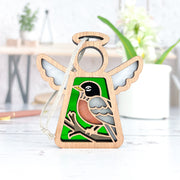 The Forged Flare® Mother's Angels® American Robin Ornament is a 3.5" wooden angel figurine with white wings, a painted robin on a branch against green, and comes with a white hanging string—ideal for bird lovers.
