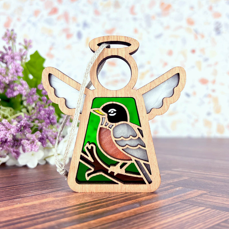 The Forged Flare® Mother's Angels® American Robin Ornament is a 3.5" wooden angel figurine, perfect for bird lovers and gift-giving. Display it on any surface as a charming decorative piece.