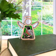 The Forged Flare® American Robin Ornament | 3.5" (H) Mother's Angels® makes a charming bird lover gift, featuring an angel figurine with robin design—ideal for display on a shelf or book.
