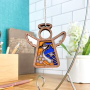 The Forged Flare® Blue Jay Ornament is a 3.5" angel figurine from Mother's Angels®, featuring stained-glass-style wings and a flower design—a thoughtful bird lover gift that's perfect for hanging as decor.