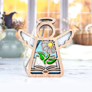 The Forged Flare® Book Lovers Ornament, a 3.5" Mother's Angels® figurine with wings, cutout book, heart, green leaves, yellow flower, and blue stained glass—an ideal author or book club gift.
