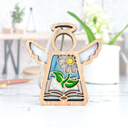 The Forged Flare® Book Lovers Ornament, a 3.5" Mother's Angels® figurine, features outstretched wings, a carved flower, an open book, and colorful stained glass—perfect as an author gift or thoughtful book club present.