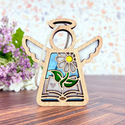 The Book Lovers Ornament by Forged Flare® is a 3.5" Mother's Angels® wooden angel figurine with cut-out wings, daisy and heart details—perfect as a book club or author gift. Stands upright on wood with painted accents.