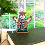 The Columbine Ornament is a 3.5" Mother's Angels® angel figurine by Forged Flare®, featuring a floral design and white wings—perfect as a charming addition to your Christmas tree décor.