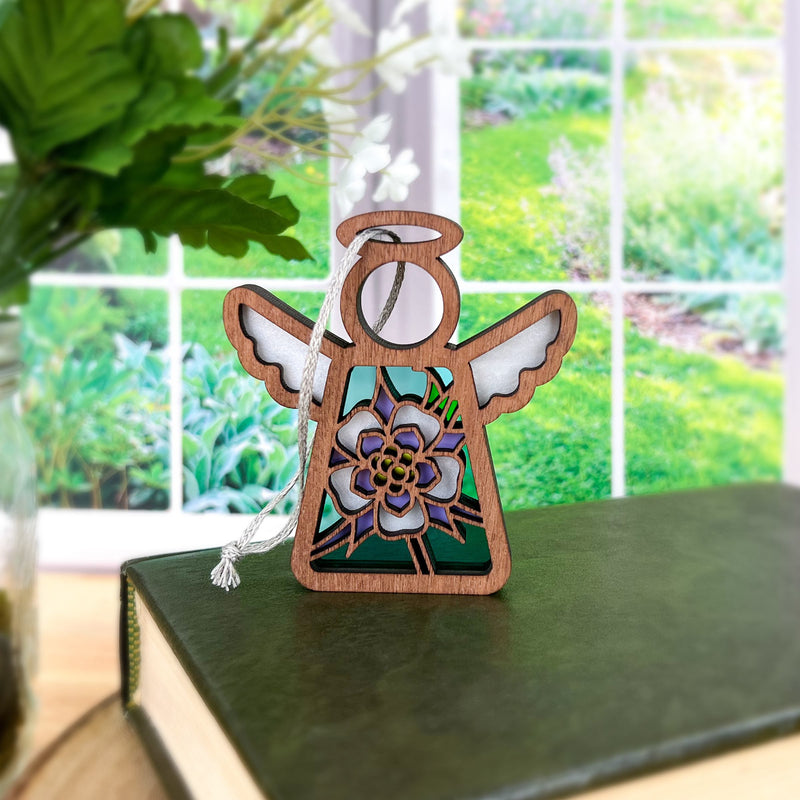 The Columbine Ornament is a 3.5" Mother's Angels® angel figurine by Forged Flare®, featuring a floral design and white wings—perfect as a charming addition to your Christmas tree décor.