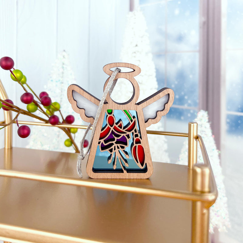 The Forged Flare® Fuchsia Ornament is a 3.5" (H) Mother's Angels® figurine with stained glass-style wings and floral details—ideal as a festive Christmas tree ornament or unique flower-themed gift.