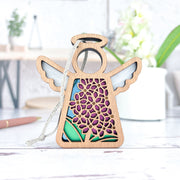 The Forged Flare® Purple Lilac Ornament is a 3.5" Mother's Angels® angel figurine with cut-out floral patterns and colorful accents, perfect as a Christmas tree ornament or decor to add a soft, cozy touch to your space.