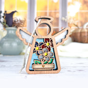 The Forged Flare® Red, White & Bloom Ornament is a 3.5" Mother's Angels® figurine with white wings and floral designs—perfect as an angel or Christmas tree ornament, displayed on any surface or amid sunlit décor.