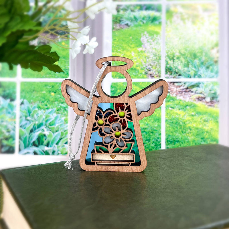 The Red, White & Bloom Ornament— a 3.5" angel figurine by Forged Flare® from the Mother's Angels® collection—features colorful floral cutouts and is perfect as a charming Christmas tree ornament or décor for any space.