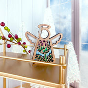 The Forged Flare® Scotch Thistle Ornament is a 3.5" (H) wooden Mother’s Angels® figurine featuring thistle details. Hanging by a string on a gold stand, it adds festive charm to your Christmas decor with its wintry theme.