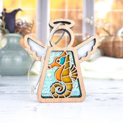The Forged Flare® Seahorse Ornament is a 3.5" Mother's Angels® wooden angel figurine with outstretched wings and a stained-glass seahorse design—ideal as a Christmas tree ornament or beach house decor.