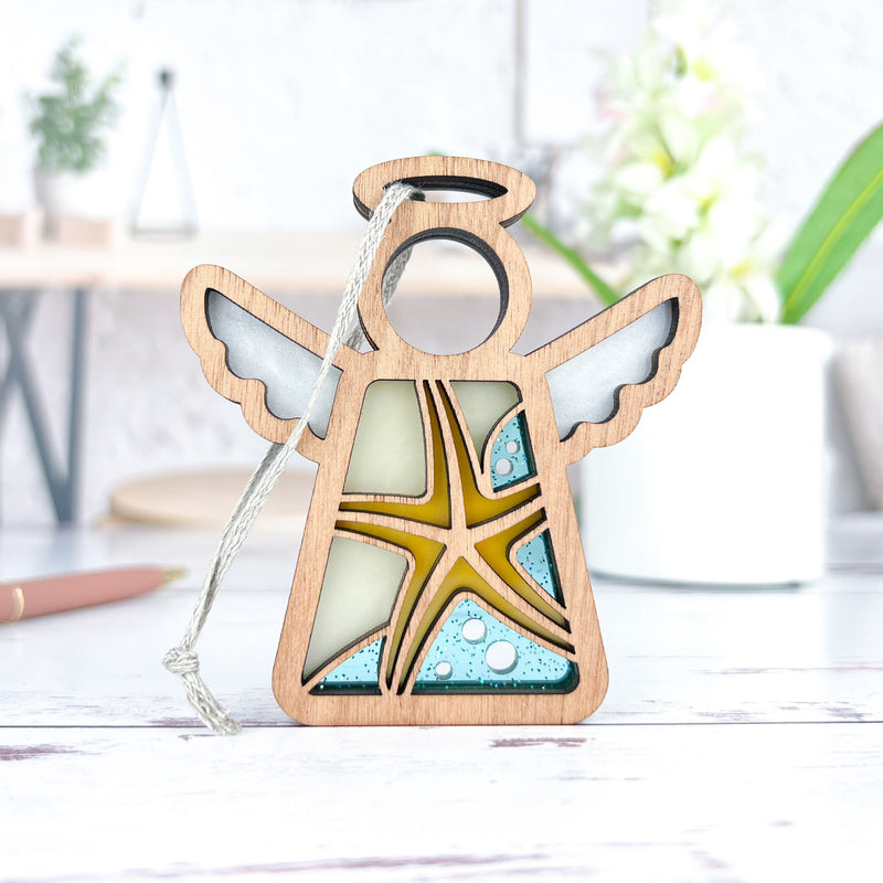 The Forged Flare® Starfish Ornament is a 3.5" Mother's Angels® figurine with airy charm, stained-glass accents, and a peaceful presence—perfect beach house decor for any serene space.