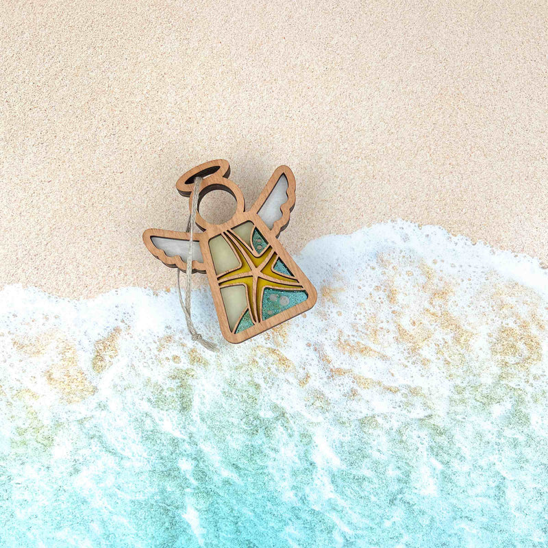 The Forged Flare® Starfish Ornament is a 3.5" Mother's Angels® figurine featuring stained-glass wings and a starfish design—ideal for adding unique beach house decor to your space.