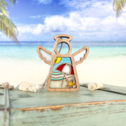 The Summer Beach Ornament by Forged Flare® is a 3.5" Mother's Angels® angel figurine featuring a white sand and blue water beach scene—umbrella, sun, and starfish—perfect coastal décor for your home.