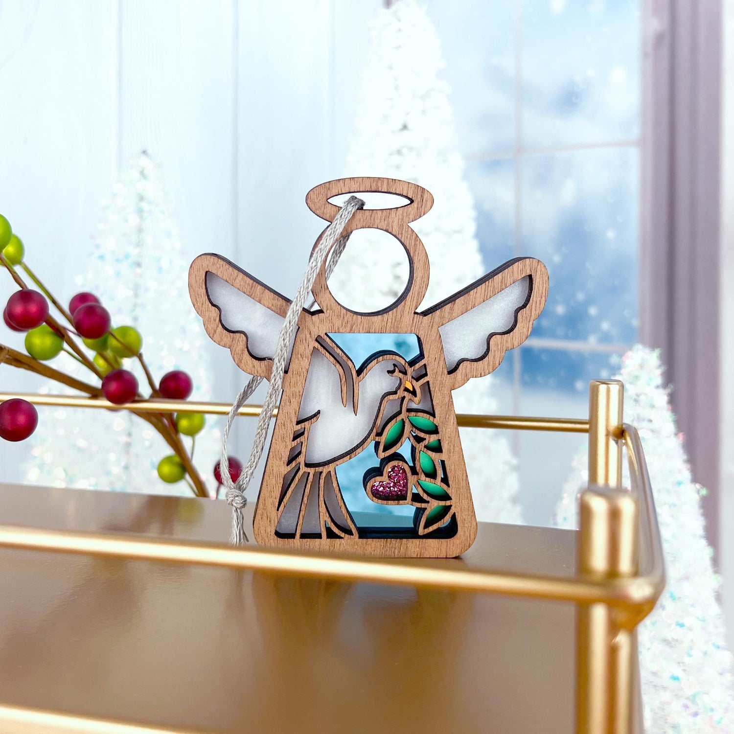 The Forged Flare® Mother's Angels® White Dove Ornament (3.5") features a dove with an olive branch and pink heart—ideal as a memorial gift or for bird lovers, and perfect for holiday decor displayed among festive accents.