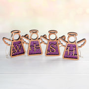Elegant purple monogram ornament set spelling 'WISH' with glittery initial letters, crafted as personalized ornaments for a festive holiday display.