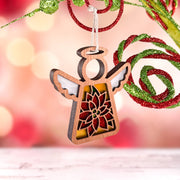 The PREORDERS CLOSED! Poinsettia Ornament by Forged Flare® is a 3.5" (H) Mother's Angels® angel figurine with white wings, hanging from a string amid sparkling red and green Christmas decorations and a soft, festive background.