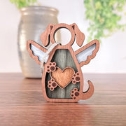 The Forged Flare® Forever In My Heart Dog Angel Ornament, featuring angel wings, a heart on its chest, and paw prints, is perfect as a personalized dog lover gift and looks beautiful displayed on any surface.